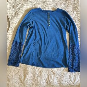 Blue long sleeve shirt with ruffles and button